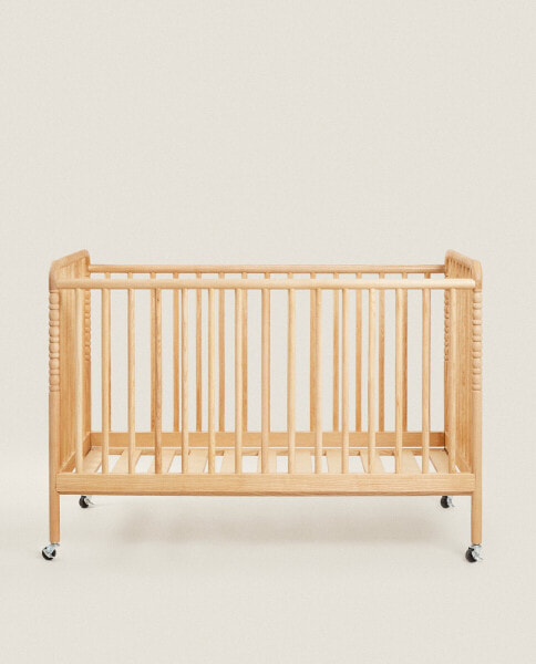 Engraved wooden cot