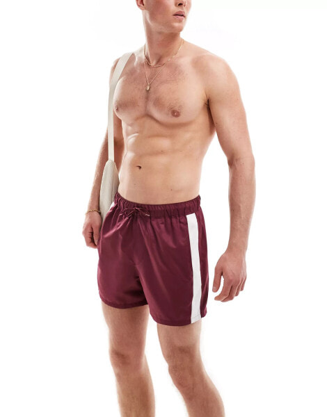 ASOS DESIGN short length swim shorts with contrast side panels in burgundy