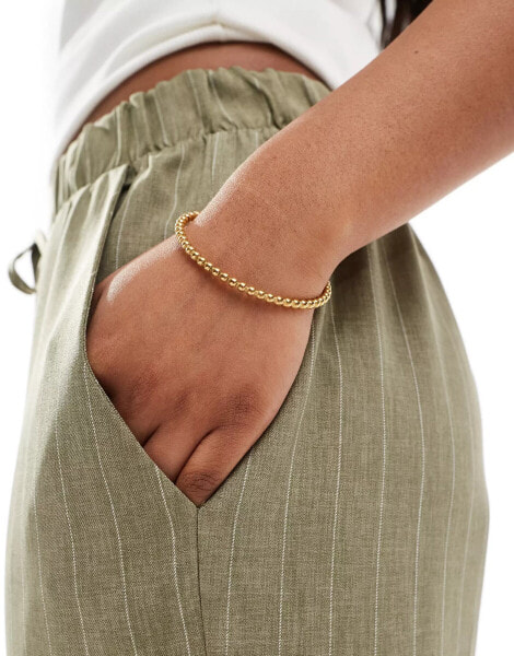 ASOS DESIGN waterproof stainless steel cuff bracelet with ball detail in gold tone