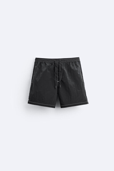 Swimming trunks with contrast topstitching