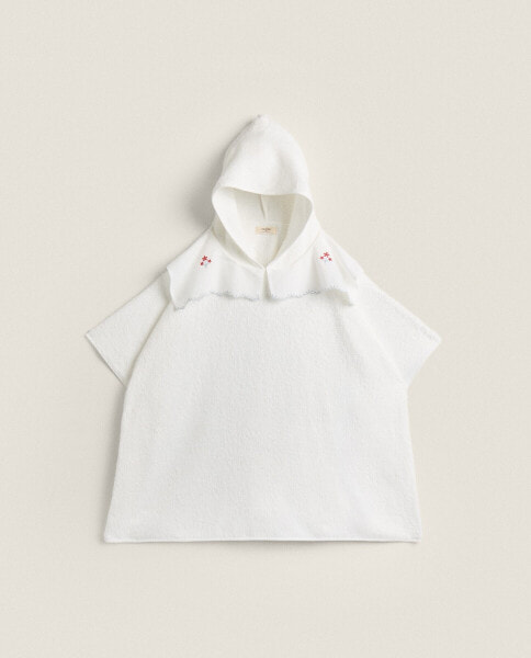 Children’s poncho with floral embroidered collar