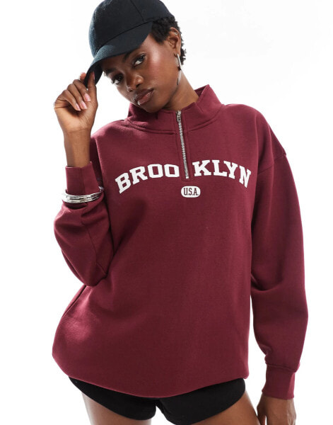 Daisy Street quarter zip sweatshirt in burgundy with large collegiate graphic