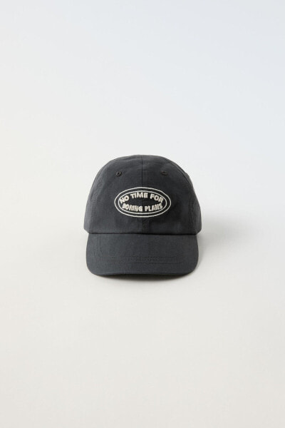 Cap with embroidered slogan