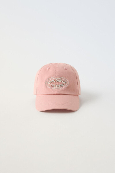 Cap with embroidered slogan