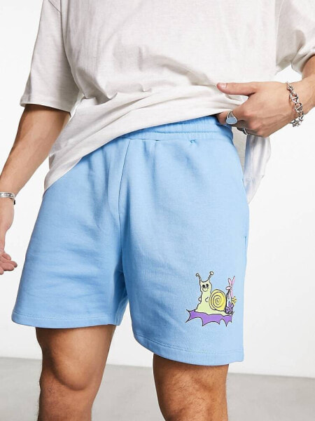 ASOS DESIGN oversized shorts in blue with cartoon print