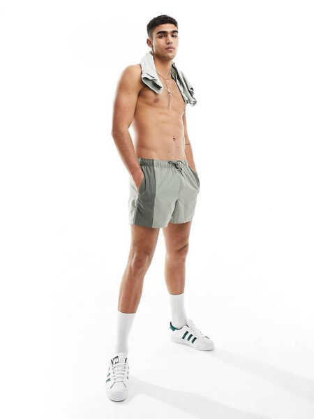 ASOS DESIGN swim shorts in short length with tonal panel design in khaki