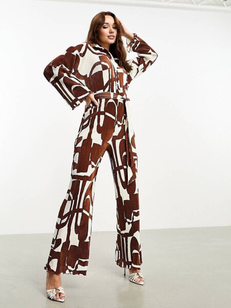 ASOS DESIGN plisse collared wide leg jumpsuit with tie waist in brown geo print