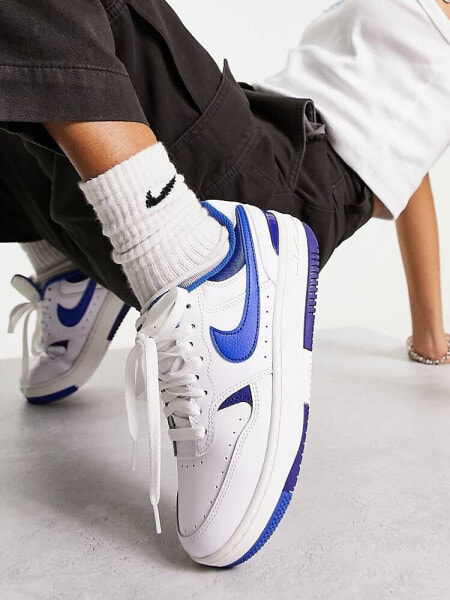 Nike Gamma Force trainers in white and game royal blue