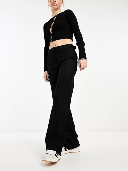 Monki low waisted trousers with side buckle detail in black