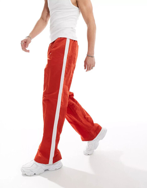 ASOS DESIGN wide nylon trousers in red with white side panel