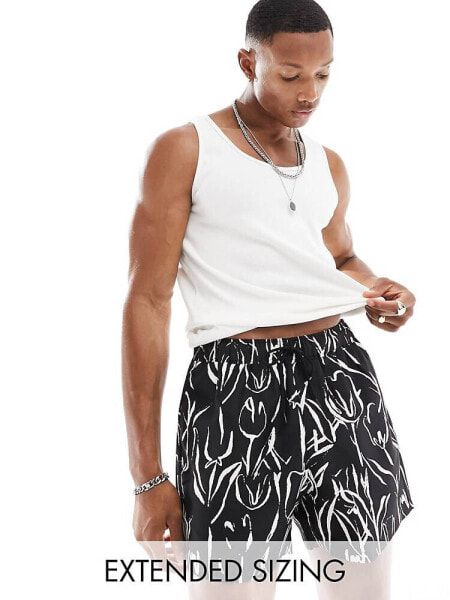 ASOS DESIGN swim shorts in short length in black and white floral print