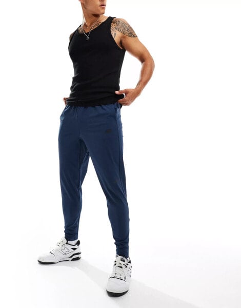 New Balance tenacity stretch woven pant in blue