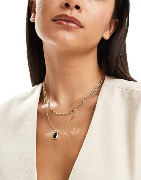 SVNX layered gold neckace with black stone pendant detail