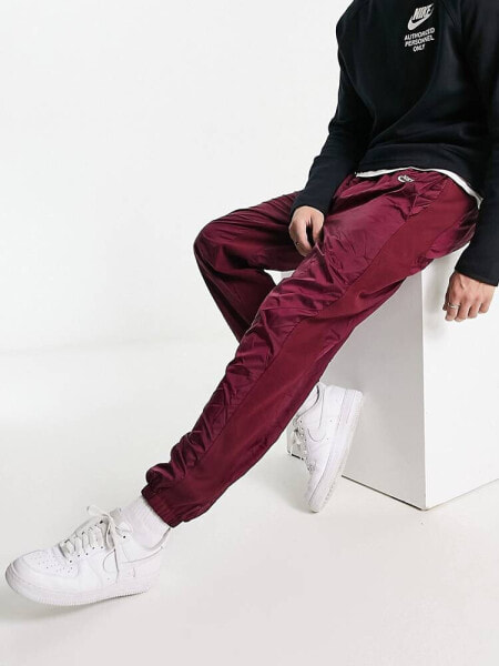 Nike Circa Premium winter textured casual trousers dark beetroot red