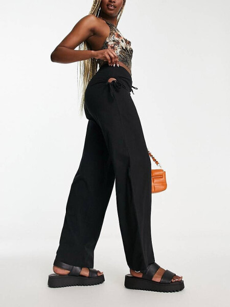 Neon & Nylon low waisted trousers with cut out detail in black