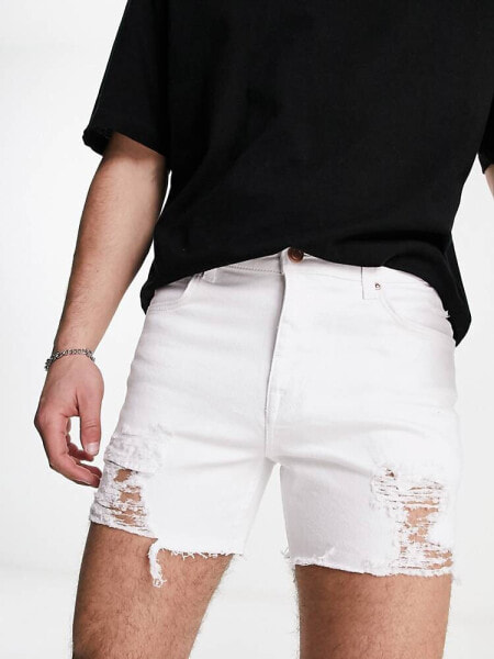 ASOS DESIGN shorter length denim shorts with rips in white