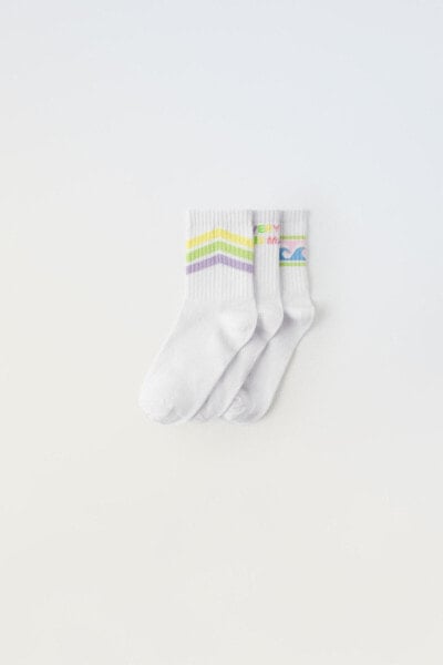 Pack of three pairs of long striped and slogan socks