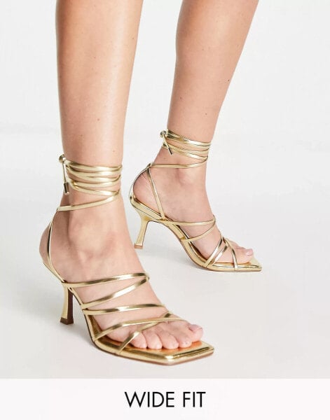 ASOS DESIGN – Hiccup – Riemchensandalen in weiter Passform mit Beinschnürung und mittelhohem Absatz in Gold