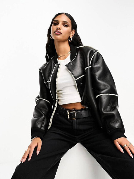 ASOS DESIGN shearling bonded bomber jacket in black and cream