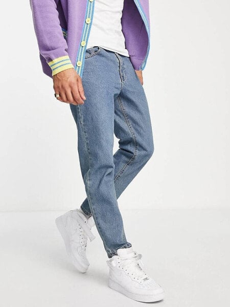 ASOS DESIGN tapered jeans in tinted light wash blue