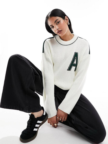 ASOS DESIGN crew neck varsity jumper in cream