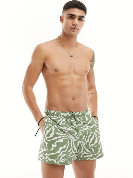 ASOS DESIGN swim shorts in short length in green abstract swirl print