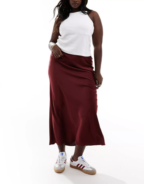 ASOS DESIGN Curve satin bias midi skirt in burgundy