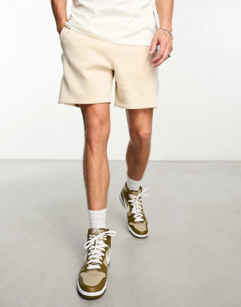 ASOS DESIGN oversized jersey shorts with poppers in beige