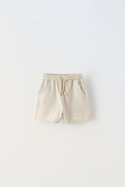 Plush bermuda shorts with embroidered slogan