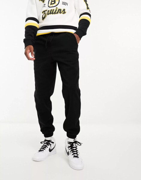 ASOS DESIGN tapered fleece joggers in black