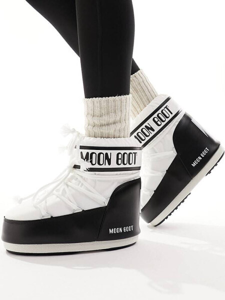 Moon Boot mid ankle snow boots in black and white 