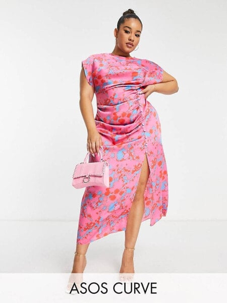 ASOS DESIGN Curve ruched side button cap sleeve satin maxi dress in pink based floral print