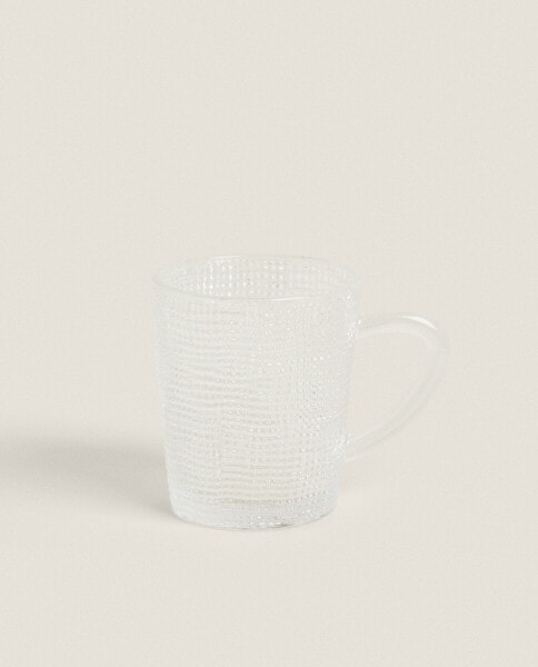 Glass cup with raised design