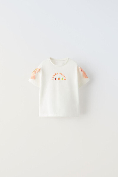 T-shirt with embroidered shoulder appliqué