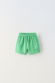 Plush bermuda shorts with label detail