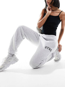 Купить женские брюки The Couture Club: The Couture Club varsity relaxed joggers in grey marl