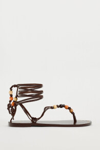 Lace-up leather sandals with beads