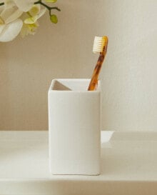 White earthenware toothbrush holder