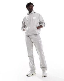 Купить мужские брюки The Couture Club: The Couture Club co-ord heavyweight emblem joggers in grey