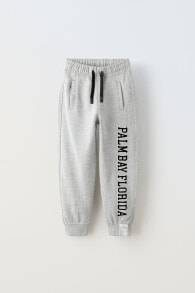 Jogging trousers with flocked slogan