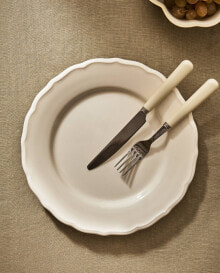 Earthenware dinner dish with raised-design edge