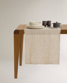 Checked linen table runner with fringing