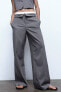 Turn-down waist trousers with topstitching