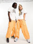 Weekday Unisex parachute baggy trousers in orange exclusive to ASOS