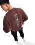 ASOS DESIGN oversized sweatshirt in brown with spine print