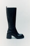 Heeled boots with track soles