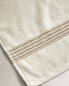 Towel with coloured thread border