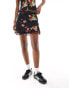 Reclaimed Vintage mini skirt with bows in black vintage floral and fruit print