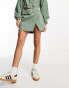 Фото #1 товара ASOS DESIGN cord wrap mini skirt in sage co-ord