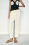 RUSTIC TROUSERS WITH DARTED HEMS